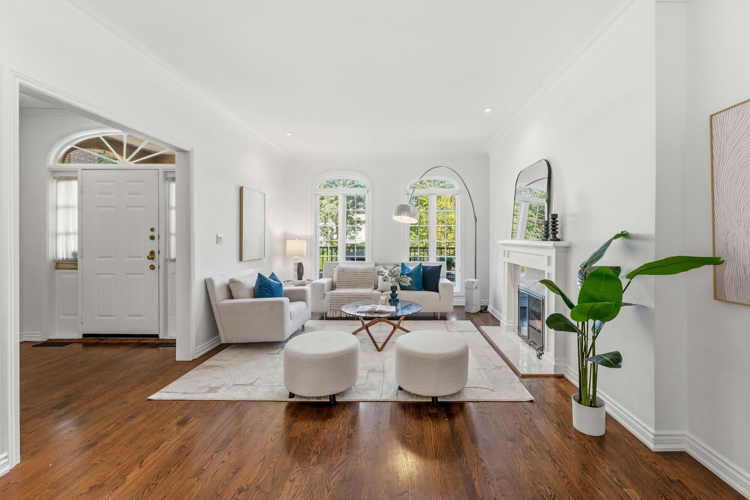 Sunlit living room with white fireplace